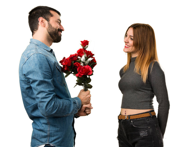 Man and woman holding flowers - Foto, Imagen