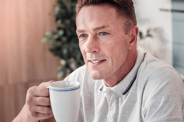 Portrait of delighted man that enjoying his morning - Photo, image