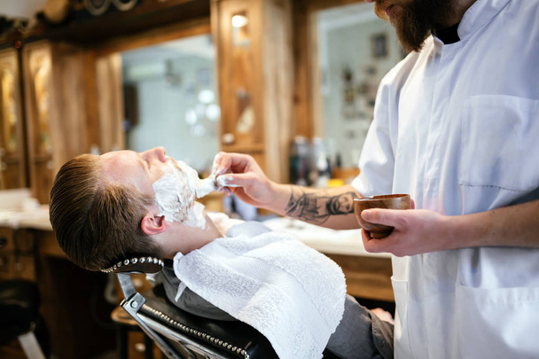 Retro shaving with foam in barber shop - Photo, Image