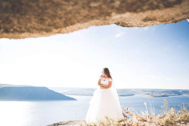 Beautiful young bride posing on the background sea - Fotó, kép
