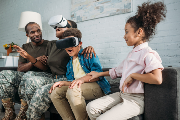 African american female and male soldiers and their children using Virtual reality headsets - Fotografie, Obrázek