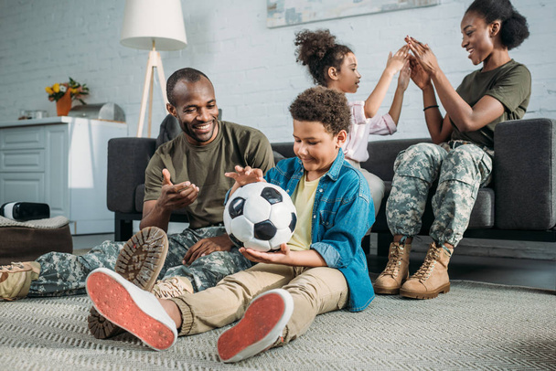 Woman and man in army uniform with their children enjoying time together - Photo, image