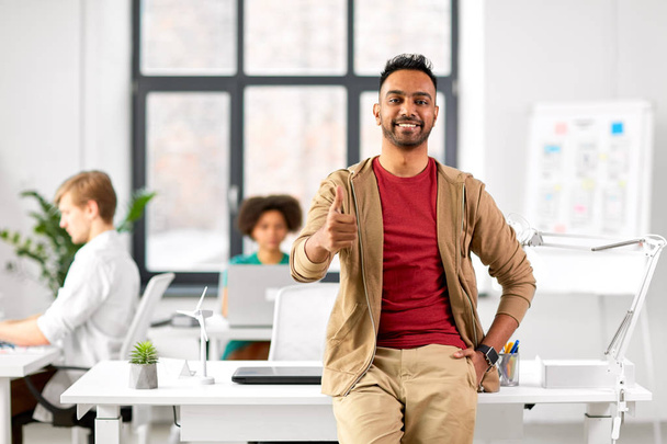 smiling indian man showing thumbs up at office - Photo, image