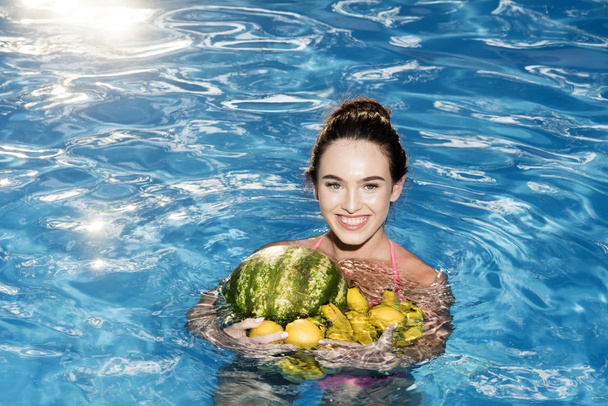 Woman relax in spa pool. Dieting and healthy organic food, vegetarian. Vitamin in banana at girl sitting near water. Summer vacation and travel to ocean. Sexy woman with tropical fruit in pool. - Foto, Bild