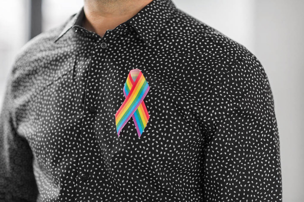 man with gay pride rainbow awareness ribbon - Foto, Imagem