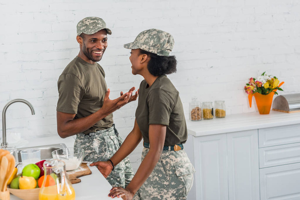 Couple of african american army soldiers talking in kitchen at home - Photo, Image