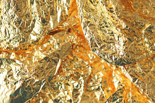 Golden shiny background. Bright golden background, sparkles and shines. A brush stroke.Foil.  - Foto, imagen