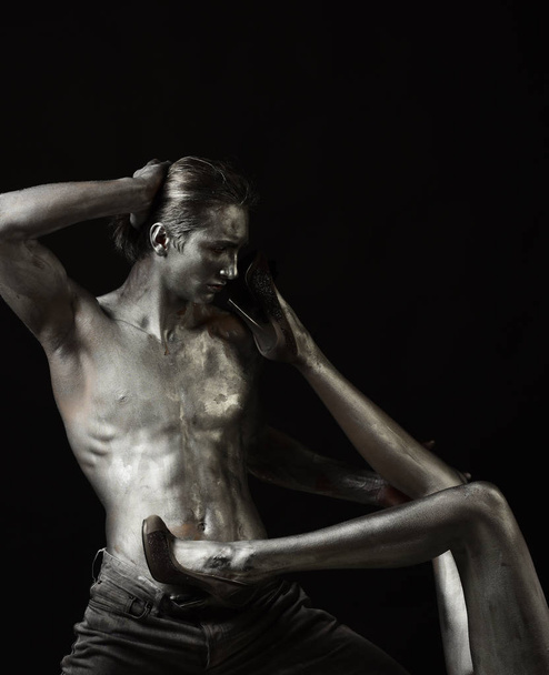 Passionate couple concept. Man with torso covered with silver paint - Photo, Image