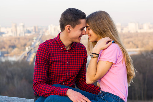 The guy laughs and hugs his girlfriend against the backdrop of t - Photo, Image