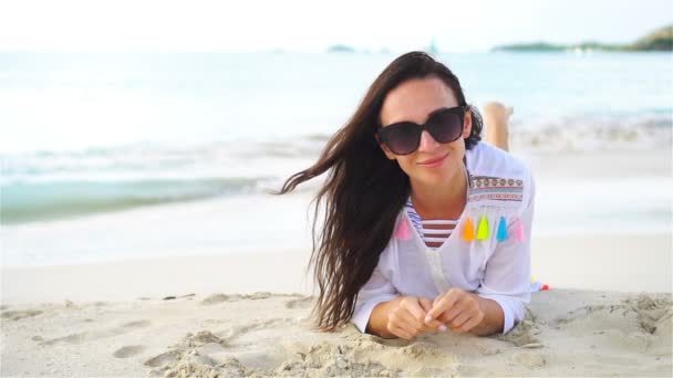 Young beautiful woman on beach during tropical vacation - Footage, Video