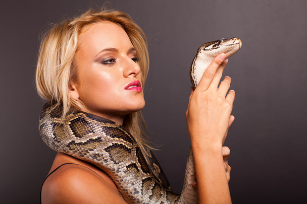 Pretty young woman holding python - Photo, image