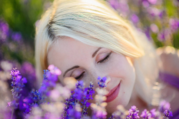 Beautiful girl in a field of lavender on sunset. - Photo, image