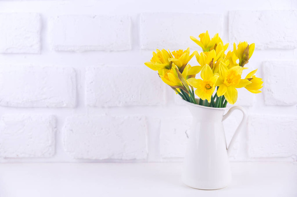 Jar with narcissuses at the white background. Spring, mothers da - Foto, Imagem