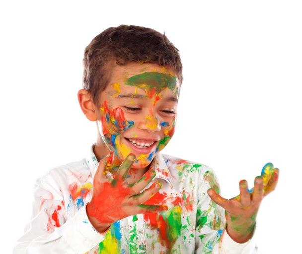 funny African boy with face covered with paint looking at hands isolated on white background - Photo, Image