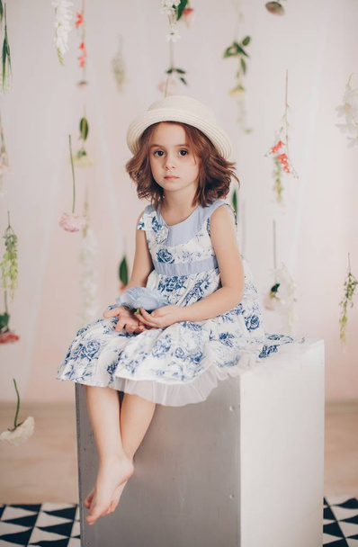 Cute little girl in dress and hat  at home, happy childhood concept  - 写真・画像