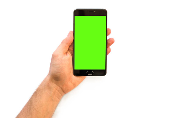 smartphone with green screen for chroma key, A man holding a comp Hand holding black smartphone with green screen for chroma key compositing - Photo, Image