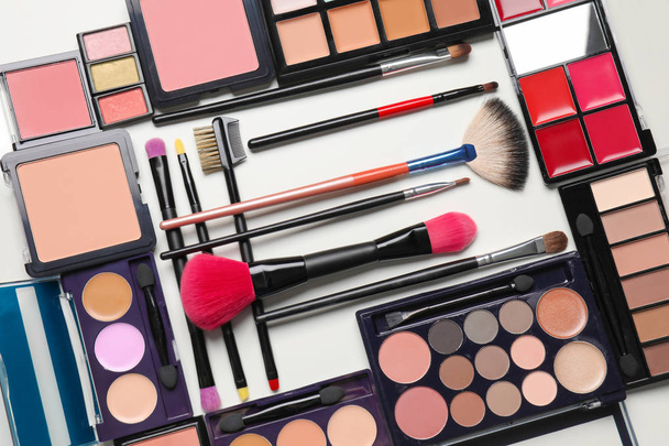 Set of decorative cosmetics and makeup brushes on white background - Photo, Image