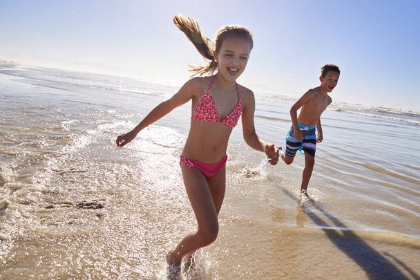 Boy And Girl On Summer Vacation Running Through Waves - Photo, image