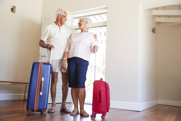 Senior Couple Arriving At Summer Vacation Rental - Photo, image