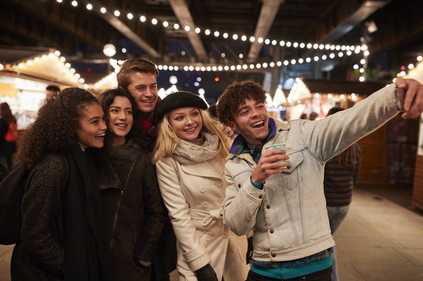 Young Friends Posing For Selfie At Christmas Market - Valokuva, kuva