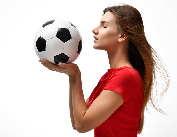 Fan sport woman player in red uniform hold soccer ball celebrating looking at the corner  - Foto, Imagem