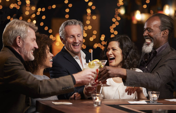 Group Of Middle Aged Friends Celebrating In Bar Together - Zdjęcie, obraz