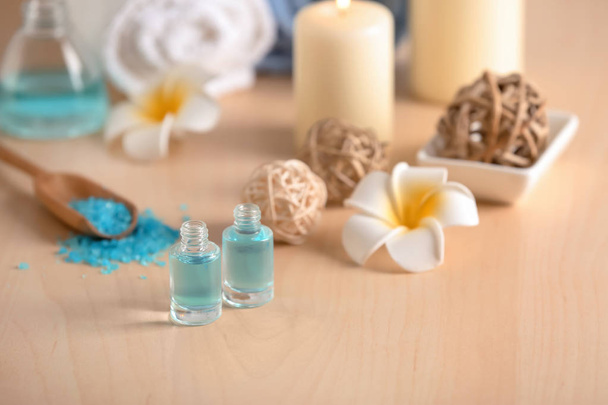 Bottles of essential oil for spa procedures on table - Fotoğraf, Görsel