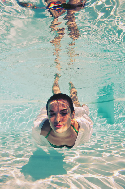 Underwater woman portrait with green bikini in swimming pool - Фото, изображение