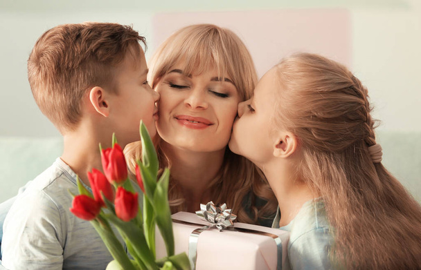 Cute little kids congratulating their mother at home - Photo, Image