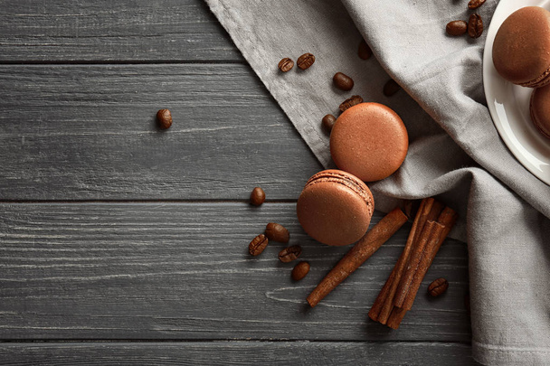 Composition with chocolate macarons on wooden background - Photo, Image
