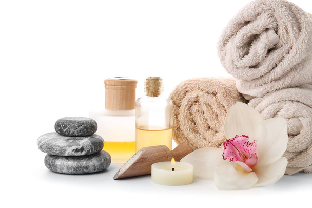 Spa composition with rolled towels and stones on white background - Fotografie, Obrázek