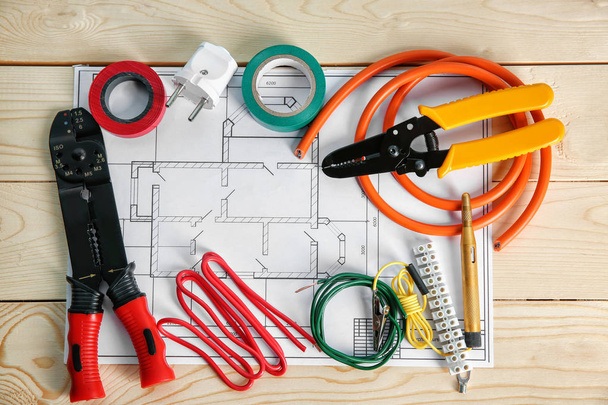 Flat lay composition with electrical tools and house plan on wooden background - Photo, Image