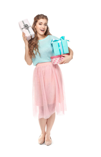 Beautiful young woman with gift boxes on white background - Fotó, kép