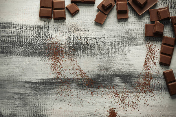 Tasty chocolate on wooden background, top view - Foto, Imagen