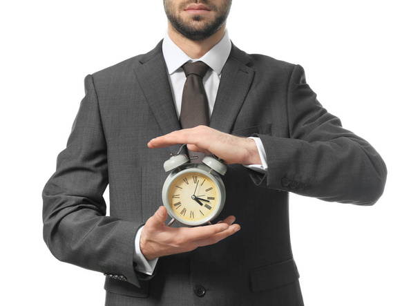Man met klok op witte achtergrond. Time management concept - Foto, afbeelding