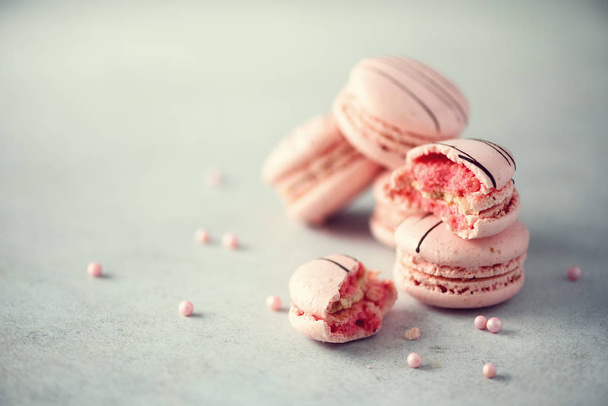 Pink french macaroons. Pastel colors macarons with copy space, top view. Holidays and celebrations concept. Sweet gift for woman, girl - Zdjęcie, obraz