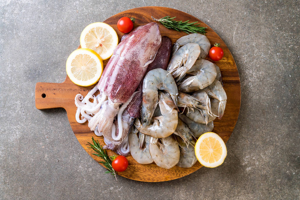 fresh seafood raw (shrimps ,squids) on wooden board  - Photo, image