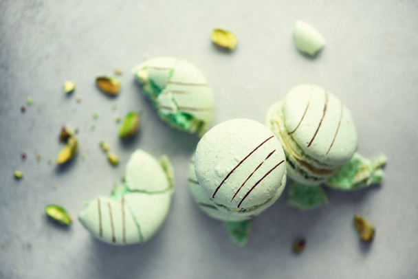Green mint french macaroons with pistachios. Pastel colors macarons, copy space. Holidays and celebrations concept. Sweet gift for woman, girl - Fotoğraf, Görsel