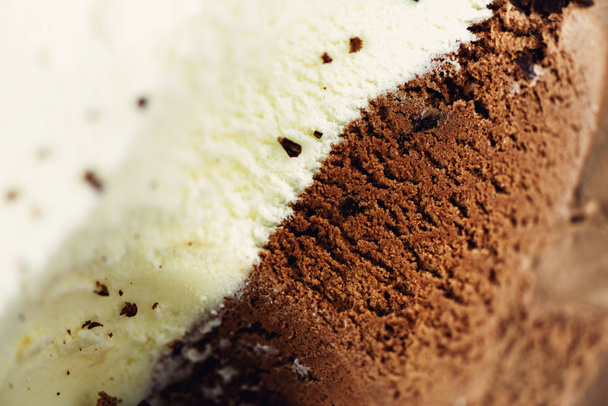Scooped vanilla and chocolate ice cream background. Summer food concept, copy space, top view. Sweet yogurt dessert or brown ice-cream texture. - Zdjęcie, obraz