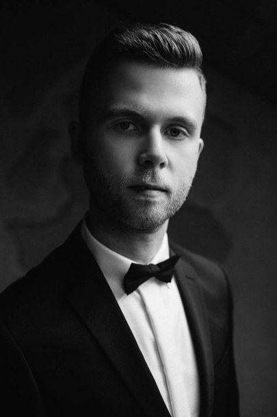 Sexy man in tuxedo and bow tie posing - Fotoğraf, Görsel