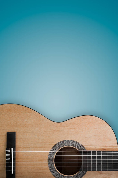 Mavi bir arka plan üzerinde bir akustik gitar parçası. - Fotoğraf, Görsel