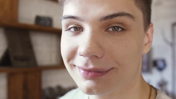 Young guy enjoys his skin looking at camera - Felvétel, videó