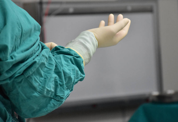 Скраб медсестра носить стерильні рукавички повністю
. - Фото, зображення