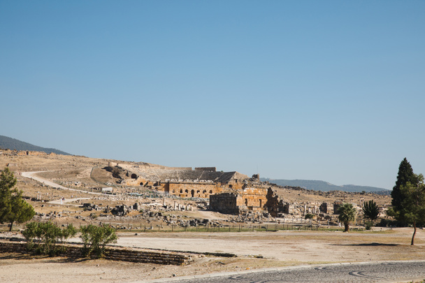 beautiful architecture, rural road and mountains on horizon in pamukkale, turkey - Photo, Image