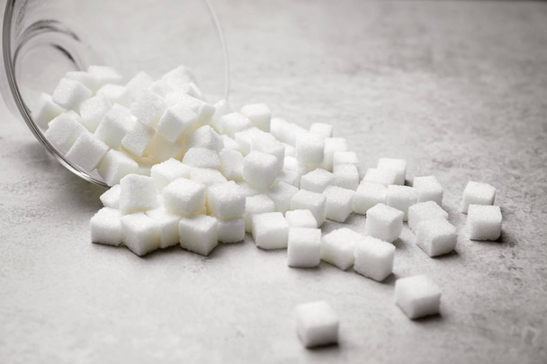 Refined sugar cubes on grey background - Фото, изображение