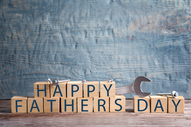 Wooden cubes and wrench on table. Father's day celebration - Foto, Imagem