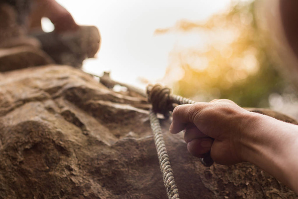 men climbing on rock outdoor, close-up image of climber hand  - Photo, Image