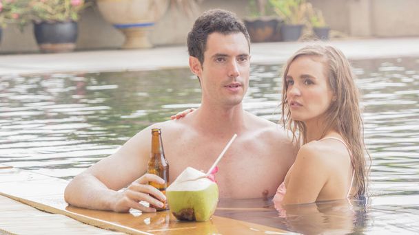 couple of man and girl sexy in fashion underwear bikini sweet love at the swimming pool with beverage alcohol and coconut juice - Фото, зображення