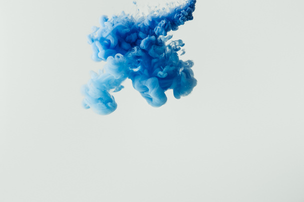 close up shot of bright blue paint splash in water isolated on gray - Foto, Imagem