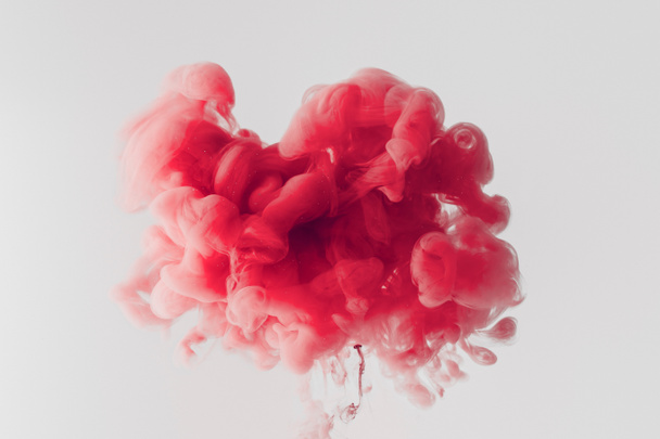 Close up shot of bright red ink
 splash in water isolated on gray - Photo, Image